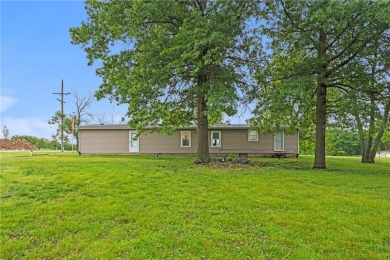 This remodeled ranch home in a gated community boasts four on Linn Valley Lakes - Deer Trace Golf Course in Kansas - for sale on GolfHomes.com, golf home, golf lot