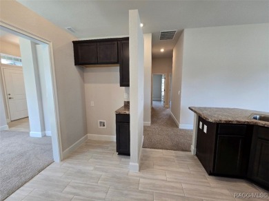 This 2020 sq. ft. home on a cul-de-sac has a partial view of the on Twisted Oaks Golf Club in Florida - for sale on GolfHomes.com, golf home, golf lot