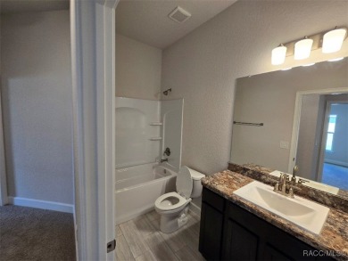 This 2020 sq. ft. home on a cul-de-sac has a partial view of the on Twisted Oaks Golf Club in Florida - for sale on GolfHomes.com, golf home, golf lot