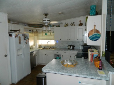 This 26x48 1984 Ventura home is located on a coveted corner lot on Grasslands Golf and Country Club in Florida - for sale on GolfHomes.com, golf home, golf lot