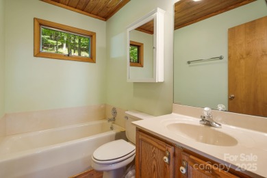 Secluded mountain cabin on three lots totaling 2.74 acres with on Wolf Laurel Country Club in North Carolina - for sale on GolfHomes.com, golf home, golf lot