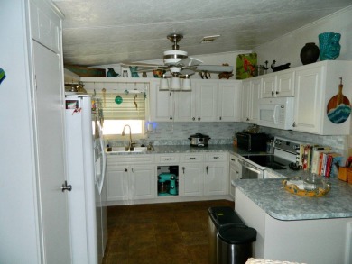 This 26x48 1984 Ventura home is located on a coveted corner lot on Grasslands Golf and Country Club in Florida - for sale on GolfHomes.com, golf home, golf lot