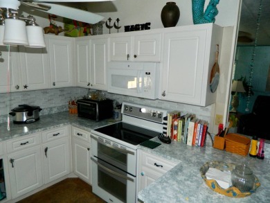 This 26x48 1984 Ventura home is located on a coveted corner lot on Grasslands Golf and Country Club in Florida - for sale on GolfHomes.com, golf home, golf lot
