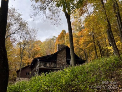 Secluded mountain cabin on three lots totaling 2.74 acres with on Wolf Laurel Country Club in North Carolina - for sale on GolfHomes.com, golf home, golf lot