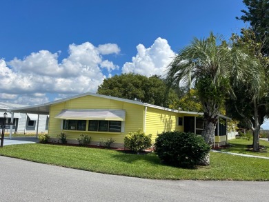 You can't beat the location of this spectacular two-bed on Lake Henry Golf Club in Florida - for sale on GolfHomes.com, golf home, golf lot