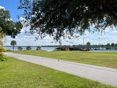 You can't beat the location of this spectacular two-bed on Lake Henry Golf Club in Florida - for sale on GolfHomes.com, golf home, golf lot