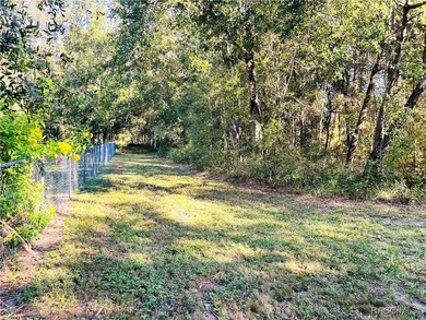 Charming three-bedroom, two-bathroom home featuring a two-car on Pine Ridge Community Golf and Country Club in Florida - for sale on GolfHomes.com, golf home, golf lot