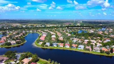Elegant two-story home located in the prestigious Weston Hills on Weston Hills Country Club in Florida - for sale on GolfHomes.com, golf home, golf lot