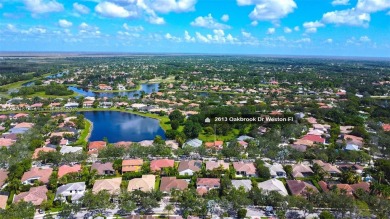 Elegant two-story home located in the prestigious Weston Hills on Weston Hills Country Club in Florida - for sale on GolfHomes.com, golf home, golf lot