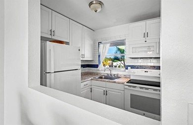 Move-in ready 1/1 condo on golf course in 55+ community. Kitchen on Leisureville Community Association in Florida - for sale on GolfHomes.com, golf home, golf lot