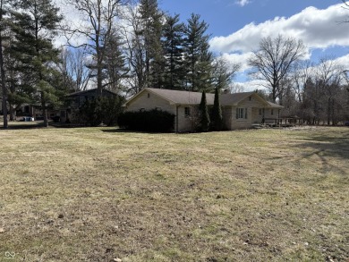 A MUST-SEE all stone ranch located in established Carmel on Woodland Country Club in Indiana - for sale on GolfHomes.com, golf home, golf lot