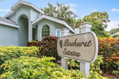 Discover tranquil living with a water view in Pinehurst Village! on Palm Aire Country Club of Sarasota in Florida - for sale on GolfHomes.com, golf home, golf lot