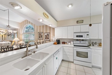 Discover tranquil living with a water view in Pinehurst Village! on Palm Aire Country Club of Sarasota in Florida - for sale on GolfHomes.com, golf home, golf lot