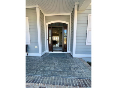 This exceptional residence is located within The Lakes at on Cape Fear National At Brunswick Forest in North Carolina - for sale on GolfHomes.com, golf home, golf lot