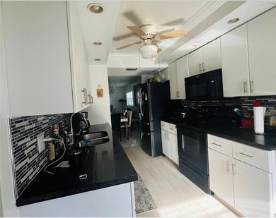 Magnificent corner unit on the convenient first floor. Swimming on Flamingo Lakes Country Club in Florida - for sale on GolfHomes.com, golf home, golf lot