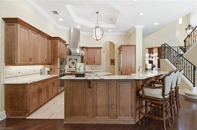 Discover refined living in this custom-built, two-story estate on Naples National Golf Club in Florida - for sale on GolfHomes.com, golf home, golf lot