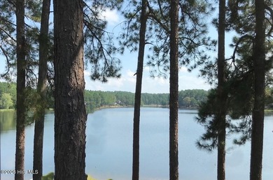 Exceptional .95-acre lakefront lot within the exclusive Pinewild on Pinewild Country Club of Pinehurst in North Carolina - for sale on GolfHomes.com, golf home, golf lot