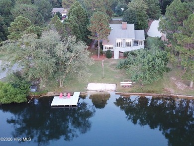 Welcome home to this beautiful lakefront property in Seven Lakes on Seven Lakes Country Club in North Carolina - for sale on GolfHomes.com, golf home, golf lot