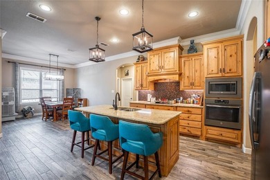 Situated high at the end of a quiet cul-de-sac, this brick and on Pecan Plantation Country Club in Texas - for sale on GolfHomes.com, golf home, golf lot