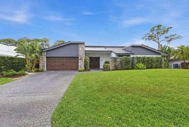 Welcome to this beautifully updated and modern 4-bedroom, 2 on Hamlet Country Club in Florida - for sale on GolfHomes.com, golf home, golf lot