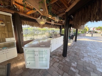 Welcome to this enchanting waterfront & golf-front tiki Lot! on Motorcoach Resort Golf Course in Florida - for sale on GolfHomes.com, golf home, golf lot