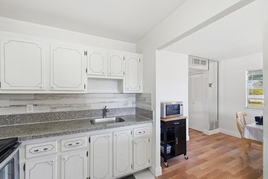 Beautiful corner unit with serene canal views in the highly on Kings Point Golf -Flanders Way in Florida - for sale on GolfHomes.com, golf home, golf lot