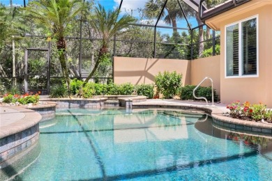 Immerse yourself in the ultimate expression of luxury living at on Shadow Wood Country Club in Florida - for sale on GolfHomes.com, golf home, golf lot