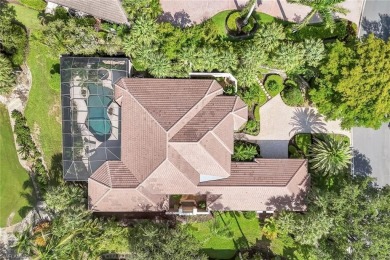 Immerse yourself in the ultimate expression of luxury living at on Shadow Wood Country Club in Florida - for sale on GolfHomes.com, golf home, golf lot