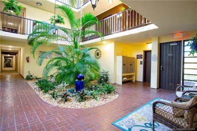 Enjoy first floor living with fantastic views from every room on Martin County Golf Course in Florida - for sale on GolfHomes.com, golf home, golf lot