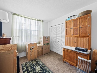 Step into South Florida living with this corner-unit stunning on Oaks Country Club in Florida - for sale on GolfHomes.com, golf home, golf lot