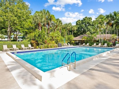 Step into South Florida living with this corner-unit stunning on Oaks Country Club in Florida - for sale on GolfHomes.com, golf home, golf lot