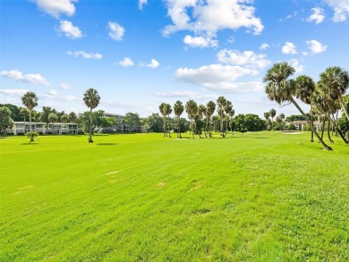 Step into South Florida living with this corner-unit stunning on Oaks Country Club in Florida - for sale on GolfHomes.com, golf home, golf lot