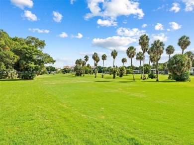 Step into South Florida living with this corner-unit stunning on Oaks Country Club in Florida - for sale on GolfHomes.com, golf home, golf lot