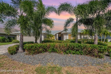 Drive up the pavered circular driveway framed by lush on Baytree National Golf Links in Florida - for sale on GolfHomes.com, golf home, golf lot