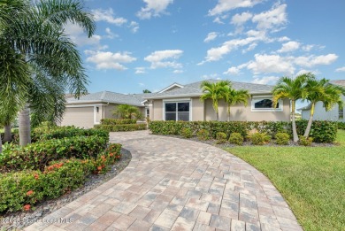 Drive up the pavered circular driveway framed by lush on Baytree National Golf Links in Florida - for sale on GolfHomes.com, golf home, golf lot