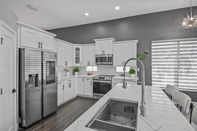 Welcome to a masterfully reimagined residence in the prestigious on Winston Trails Golf Course in Florida - for sale on GolfHomes.com, golf home, golf lot