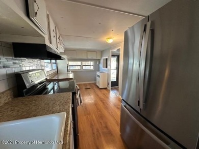 NO LOT RENT, it is a deeded lot, 2 bedrooms 1-1/2 Baths on Tooke on Glen Lakes Country Club in Florida - for sale on GolfHomes.com, golf home, golf lot