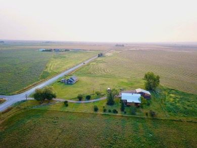 A log-style residence sits on the peaceful plains of central on Choteau Country Club in Montana - for sale on GolfHomes.com, golf home, golf lot