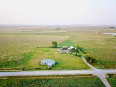 A log-style residence sits on the peaceful plains of central on Choteau Country Club in Montana - for sale on GolfHomes.com, golf home, golf lot