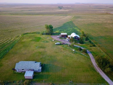 A log-style residence sits on the peaceful plains of central on Choteau Country Club in Montana - for sale on GolfHomes.com, golf home, golf lot