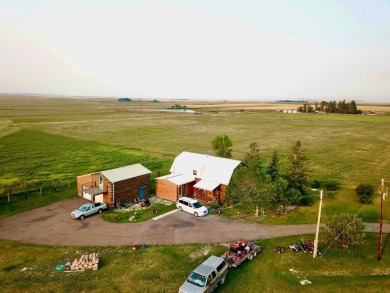 A log-style residence sits on the peaceful plains of central on Choteau Country Club in Montana - for sale on GolfHomes.com, golf home, golf lot