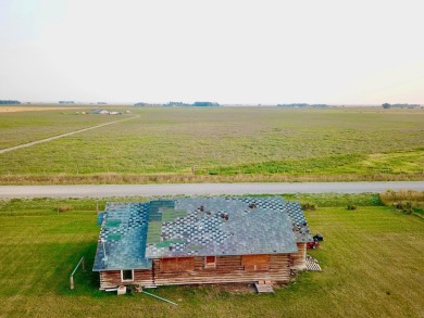 A log-style residence sits on the peaceful plains of central on Choteau Country Club in Montana - for sale on GolfHomes.com, golf home, golf lot