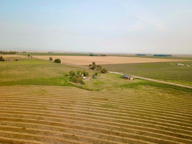 A log-style residence sits on the peaceful plains of central on Choteau Country Club in Montana - for sale on GolfHomes.com, golf home, golf lot