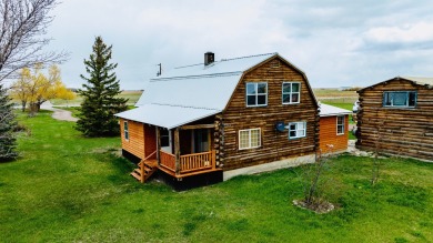 A log-style residence sits on the peaceful plains of central on Choteau Country Club in Montana - for sale on GolfHomes.com, golf home, golf lot