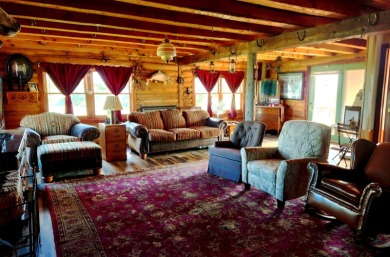 A log-style residence sits on the peaceful plains of central on Choteau Country Club in Montana - for sale on GolfHomes.com, golf home, golf lot