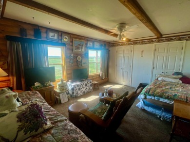 A log-style residence sits on the peaceful plains of central on Choteau Country Club in Montana - for sale on GolfHomes.com, golf home, golf lot