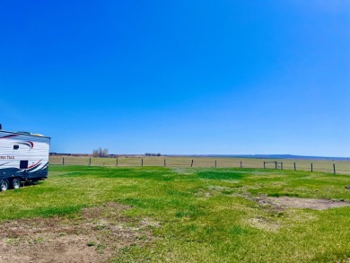 A log-style residence sits on the peaceful plains of central on Choteau Country Club in Montana - for sale on GolfHomes.com, golf home, golf lot