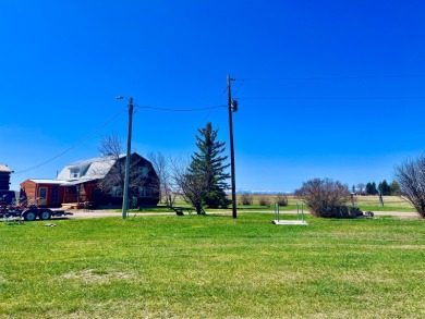 A log-style residence sits on the peaceful plains of central on Choteau Country Club in Montana - for sale on GolfHomes.com, golf home, golf lot