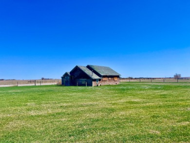 A log-style residence sits on the peaceful plains of central on Choteau Country Club in Montana - for sale on GolfHomes.com, golf home, golf lot