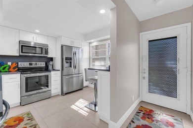 Discover this beautifully remodeled residence where elegance on Wynmoor Golf Course in Florida - for sale on GolfHomes.com, golf home, golf lot